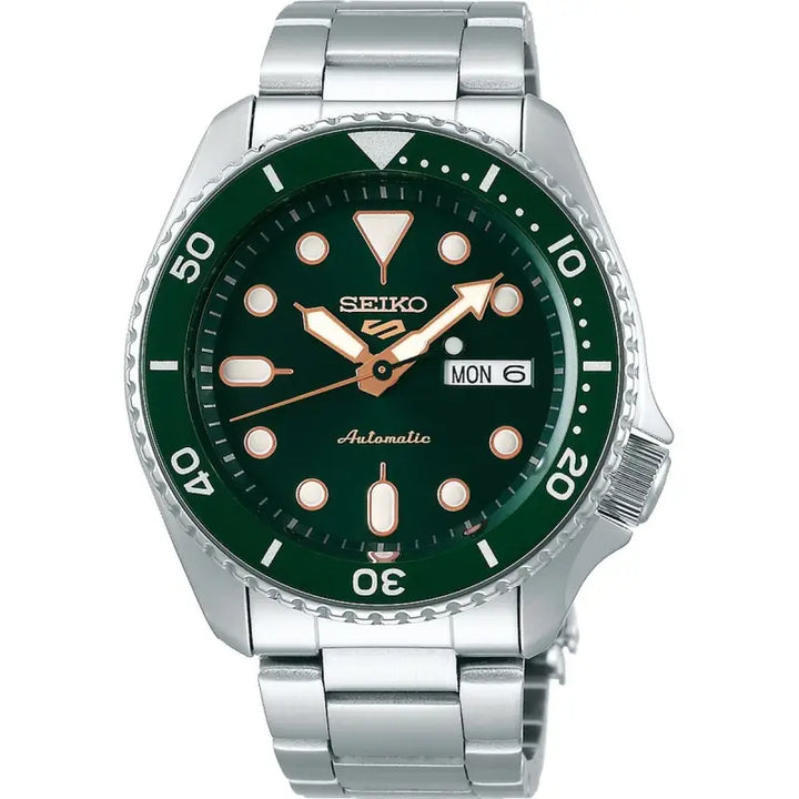 Stainless steel men's Seiko 5 automatic watch with a green dial, silver hands and markers, and a rotating bezel. The watch is displayed on a white background.